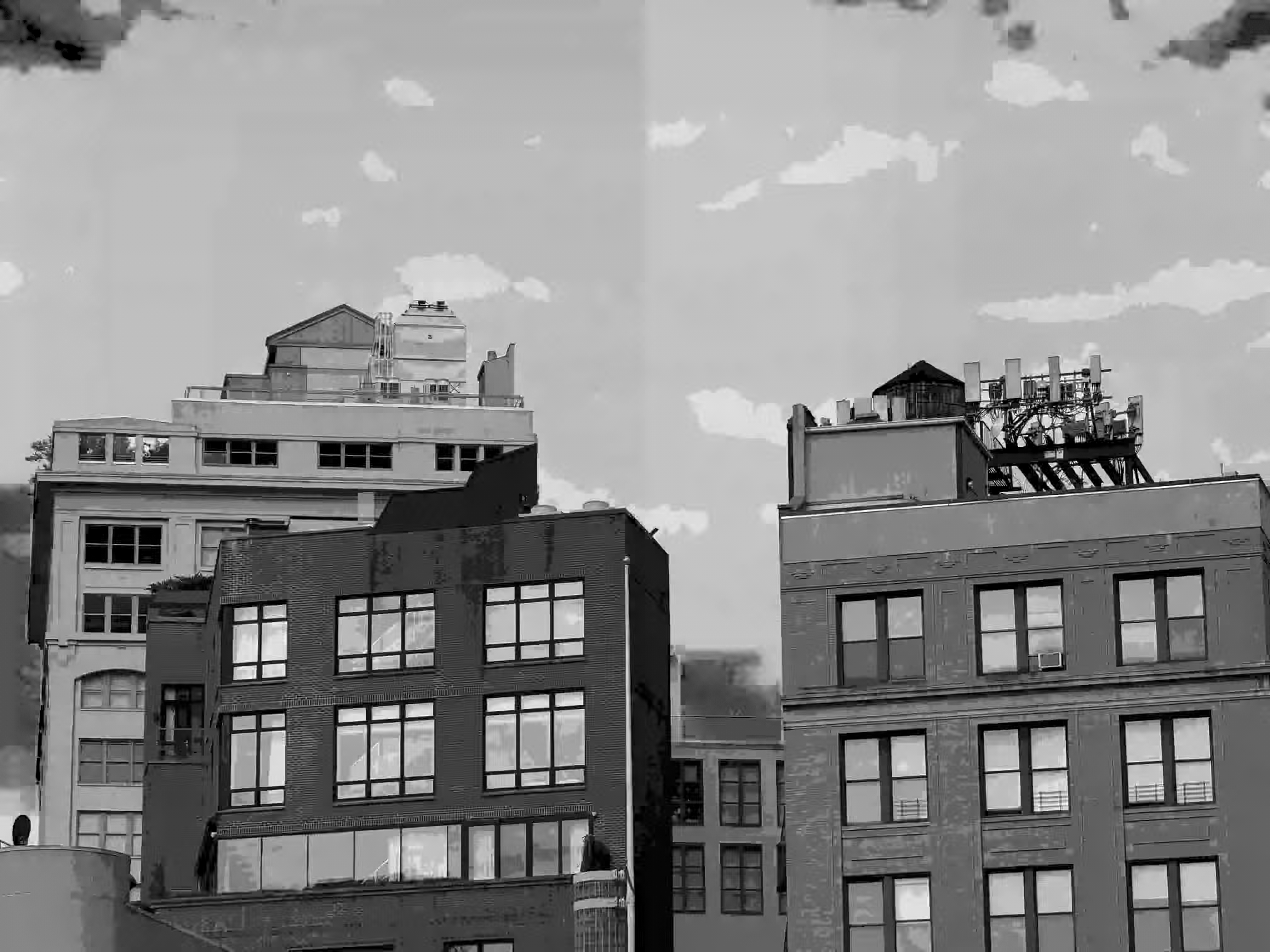 split sky A slight crack in the sky separates poster-shaded monochrome apartment buildings