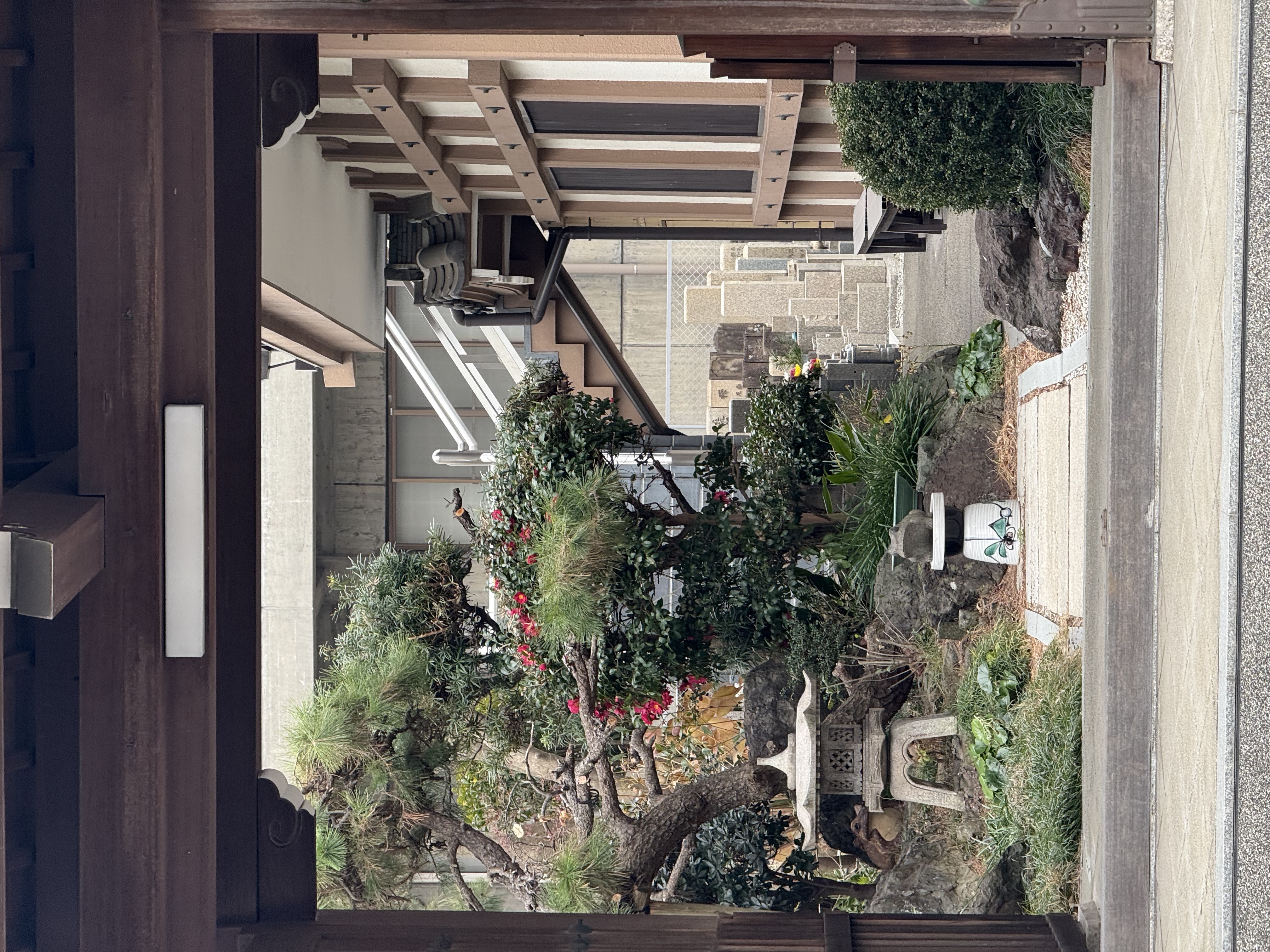 The inner courtyard of a small temple as viewed from the gate outside