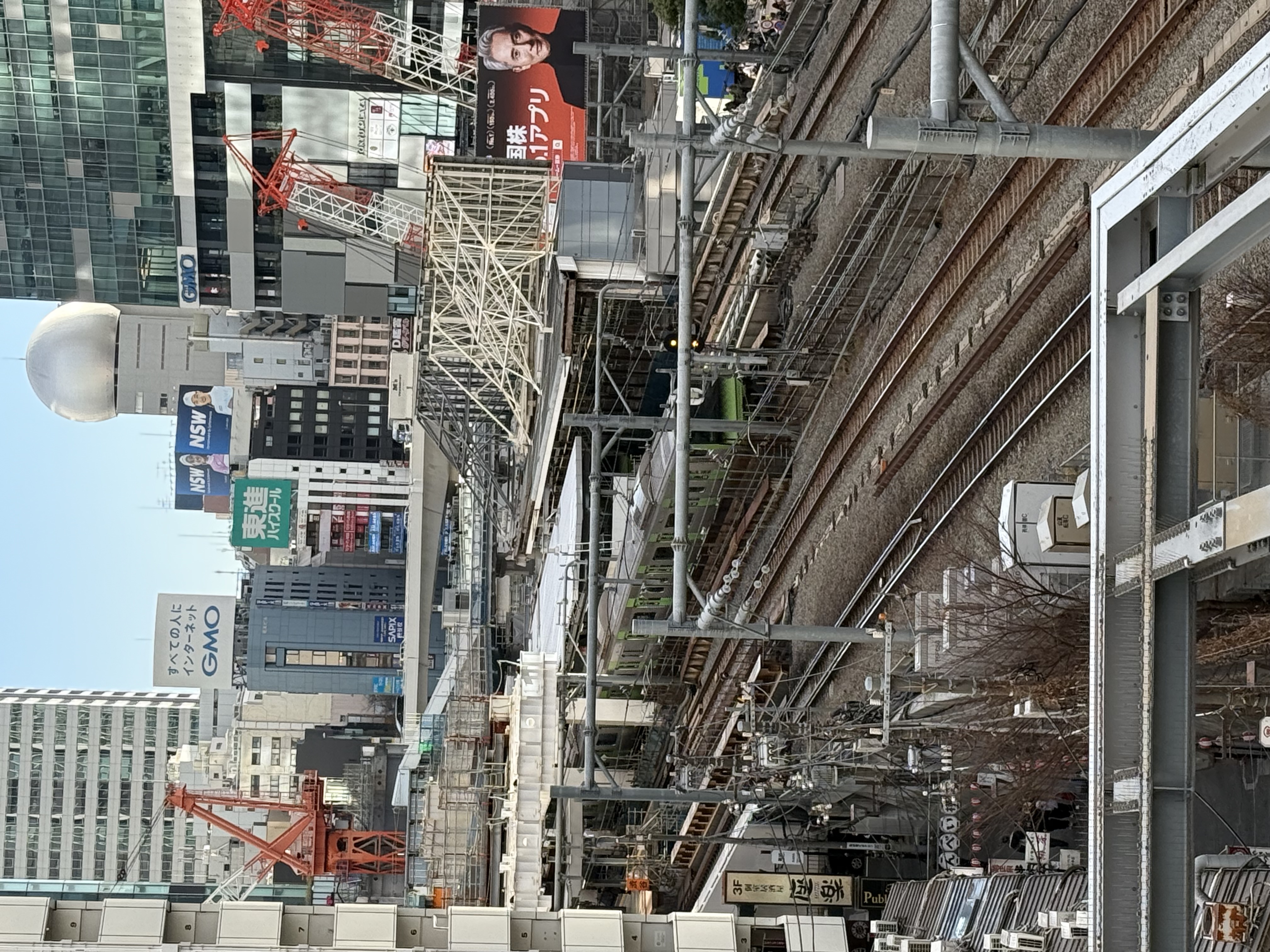 A bustling downtown area builds up and around train lines