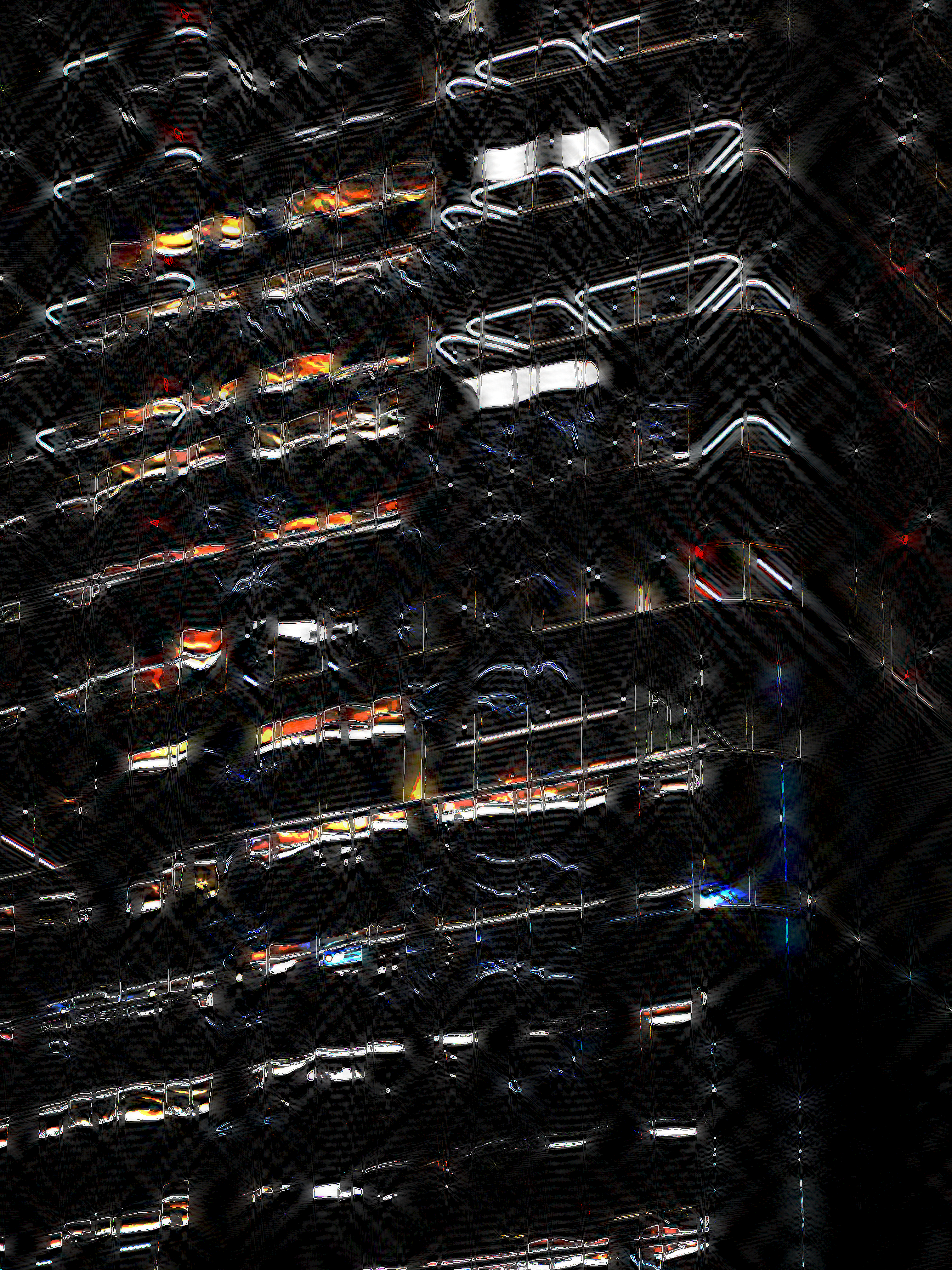 looking up at a building emerging from the dark, only its lights visible, shining so bright they saturate all primary hues to form a brilliant white, causing wavy streaks in-line with the angle you're looking at it. it's like a spaceship, or a futuristic prison.