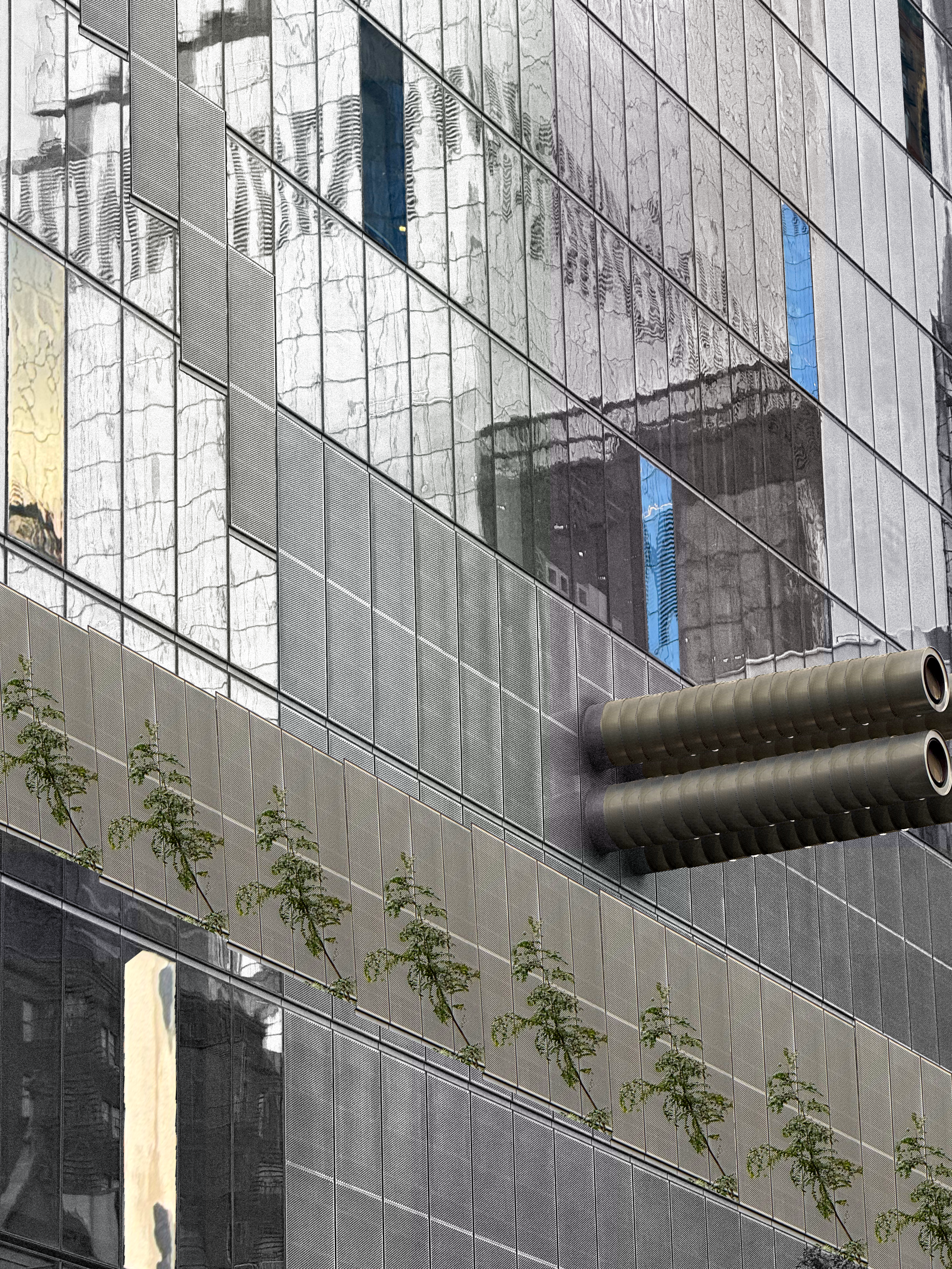 different windowpanes on a building have been swapped with each other (accounting for perspective distortion) and other parts, like some pipes, metal grill, and a lone tree branch have been cut-and-pasted. everything that resulted from this transformation is intensely saturated, especially compared to the almost-black-and-white rest of scene.