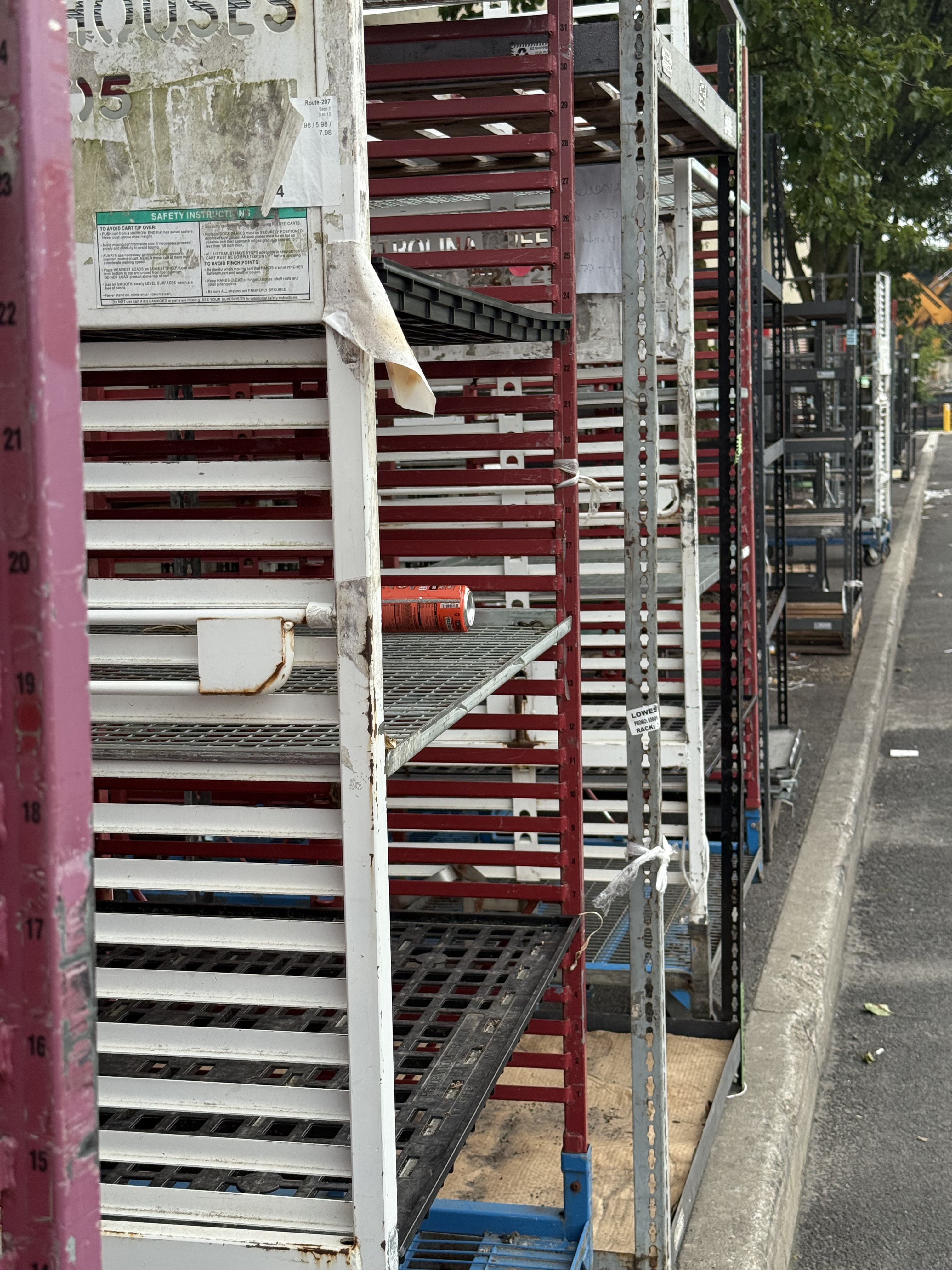 rows of old empty metal shelving line the parking lot