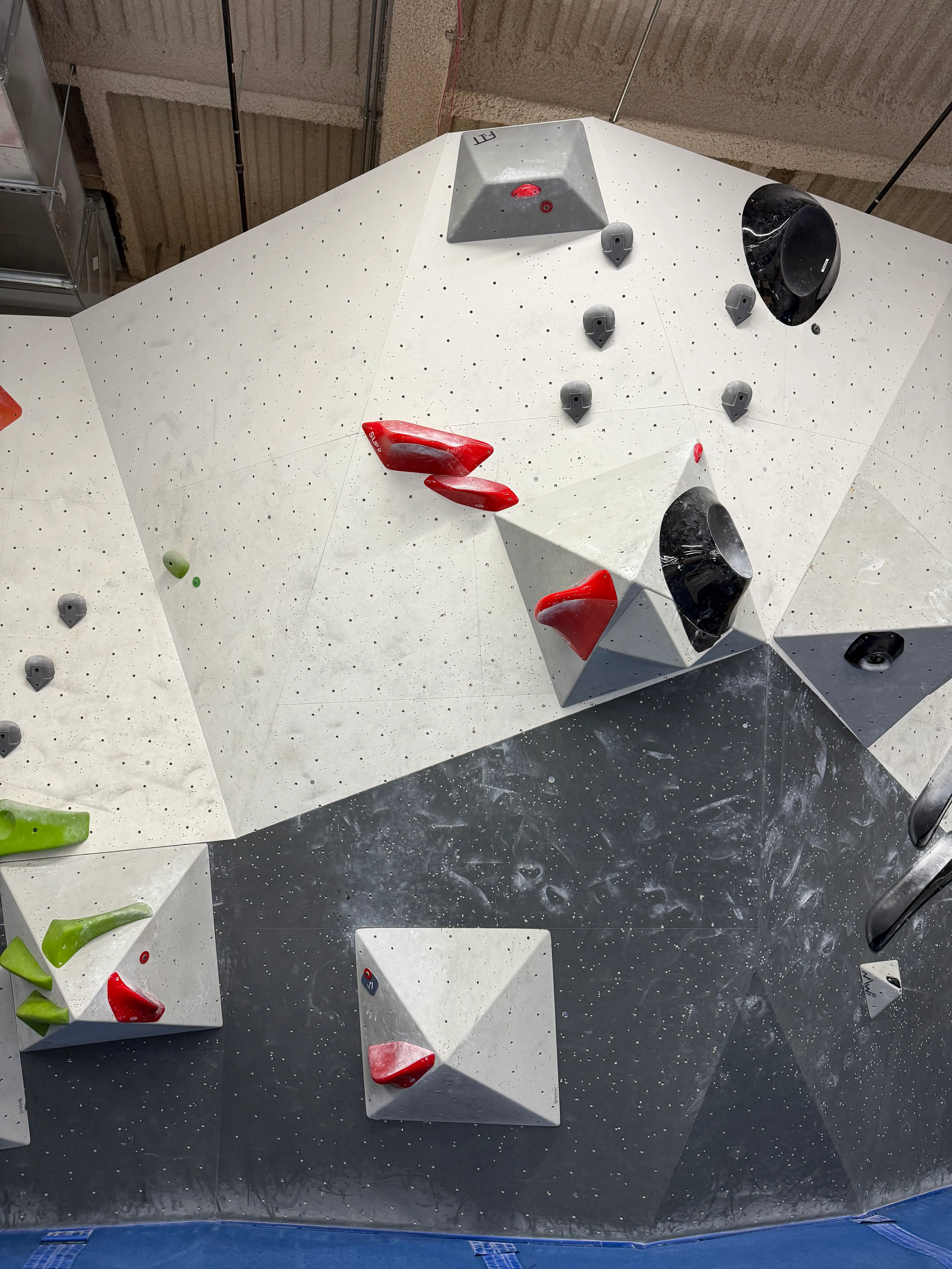 Red V7 with a double start in the corner between two volumes. Both start holds are like platforms. The next hold is a narrow pincher with a wide platform (so, easy to grab) connected to a volume sticking far out from the wall on the right (so you have to jump to it), then two more slightly smaller of the same that are on the wall to the left of the volume. There&#x27;s a pretty good crimp on the far side of the upper volume, and the top finishes with an upside-down hold directly above the hold you jump to.