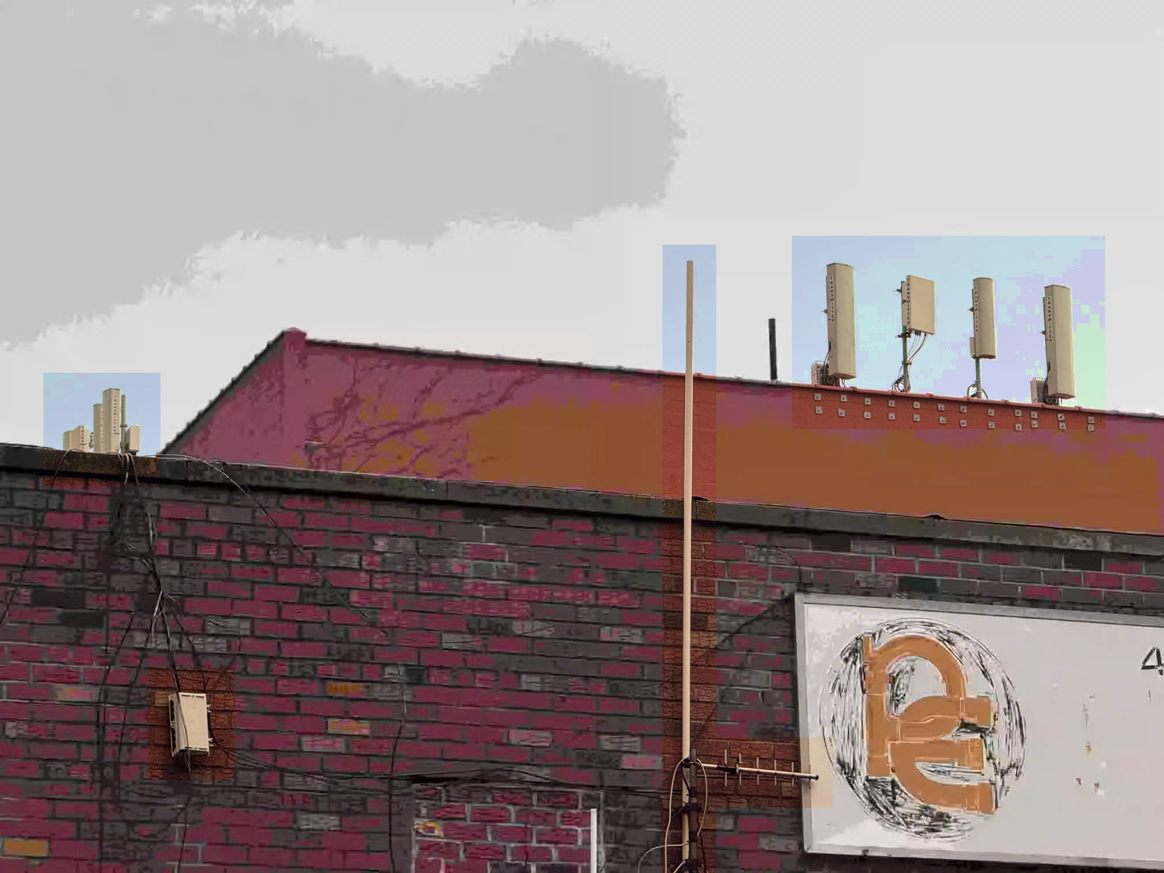 Small cellular and radio antennae are blocked out in high saturation against a gray sky