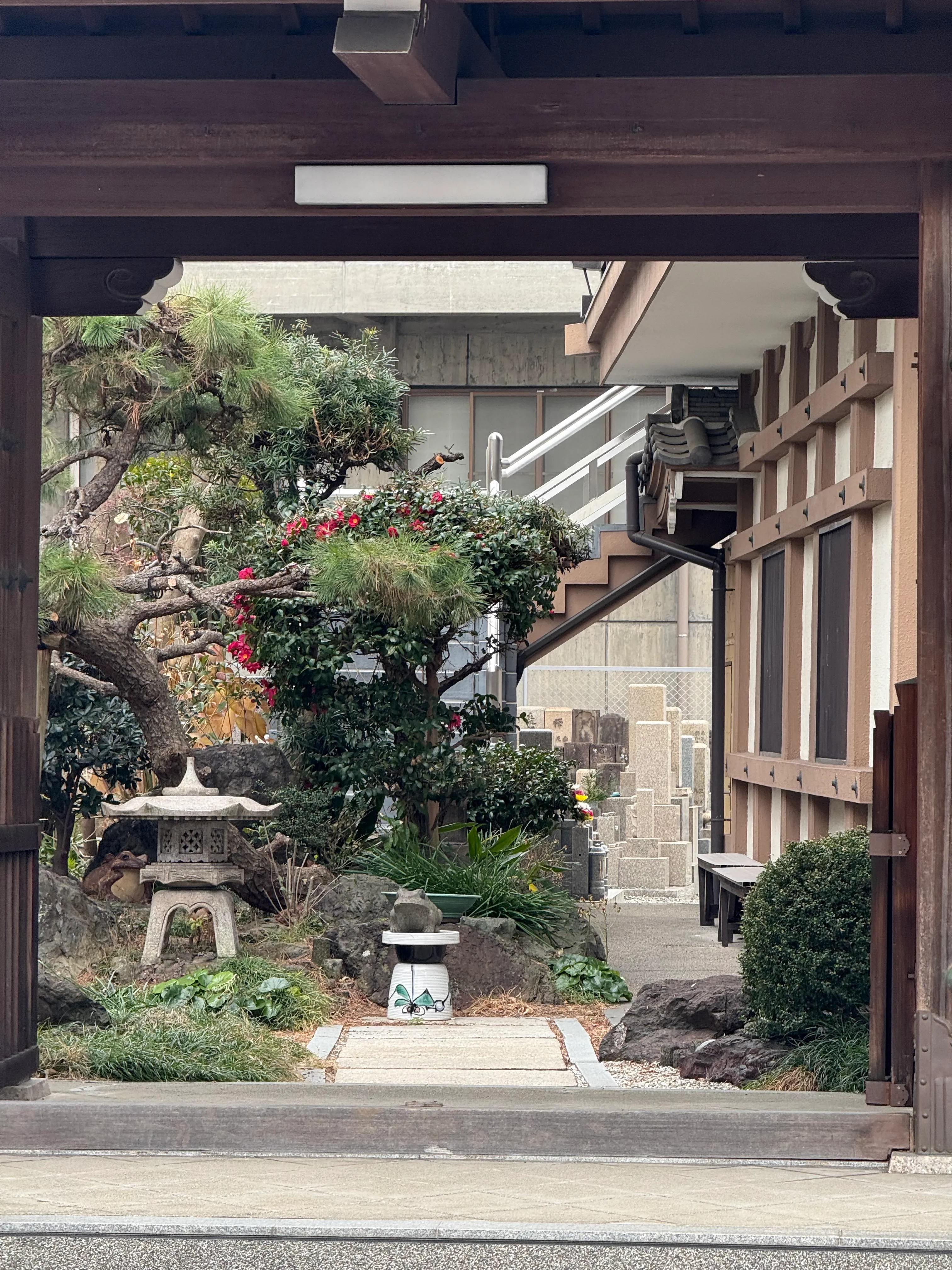 The inner courtyard of a small temple as viewed from the gate outside