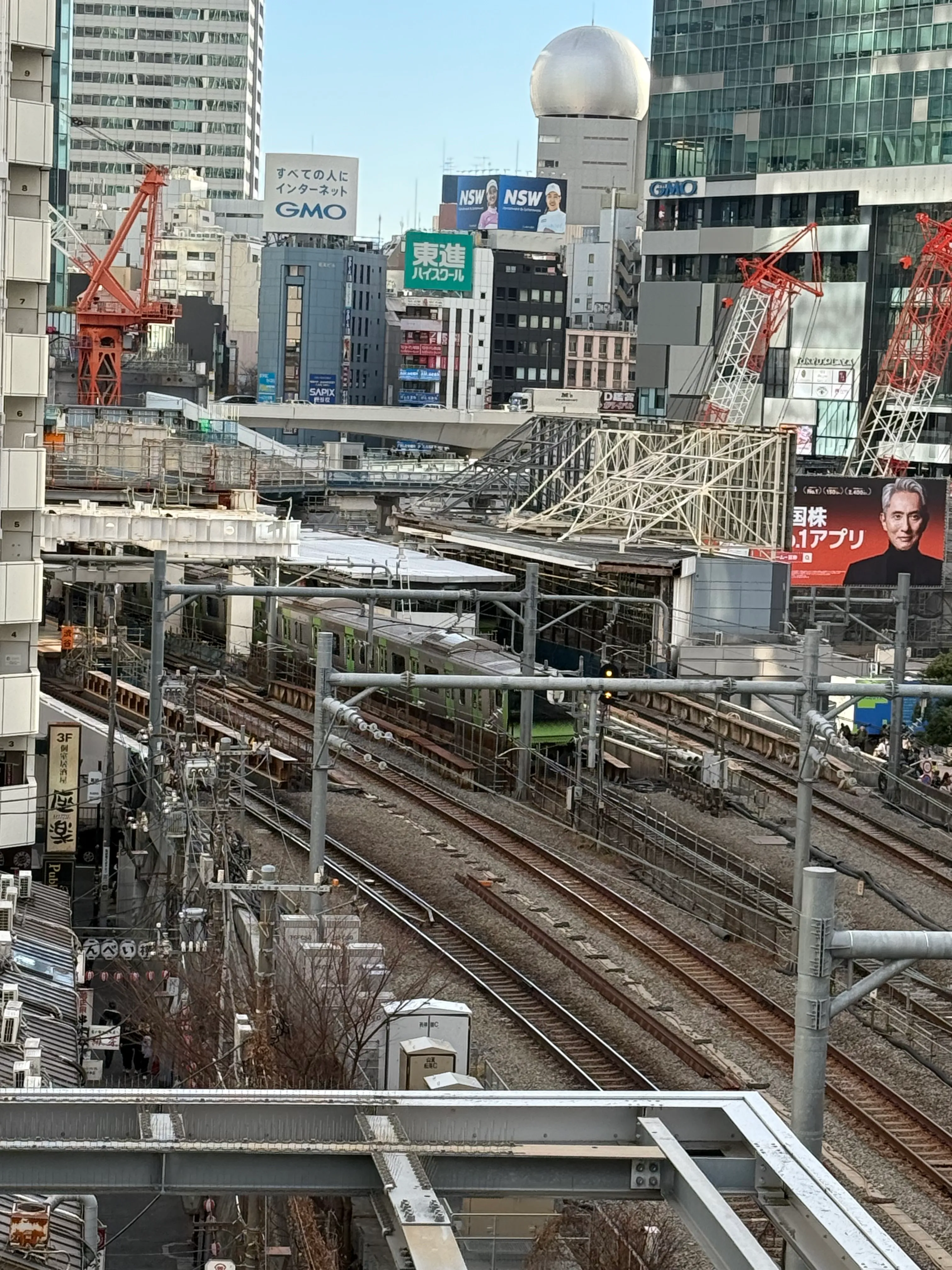 A bustling downtown area builds up and around train lines